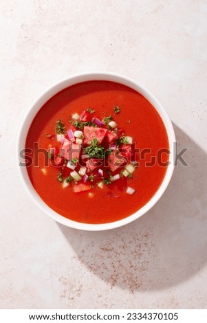 Spanish tomato and watermelon gazpacho cold soup styled and decorated in white plate Royalty-Free Stock Photo #2334370105