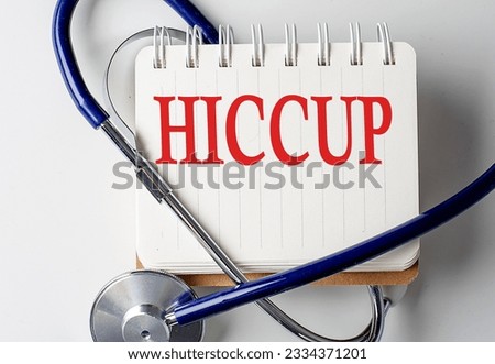 HICCUP word on a notebook with medical equipment on background