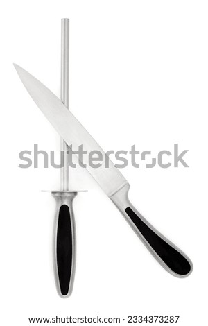 Stainless steel carving knife and sharpener, over white background.