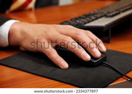 people at work- close-up of a businessman using a mouse
