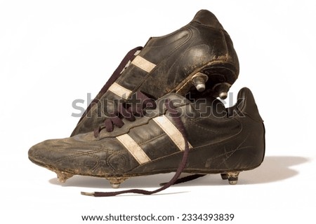 A pair of old football boots, showing signs of good use and age