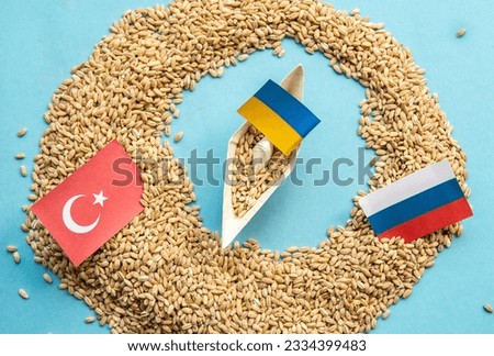Ukrainian ship grain wheat, Turkey and Russia flags background.   Grain deal and problem of blockade of ports, grain corridor, Ukraine Russia conflict. Royalty-Free Stock Photo #2334399483