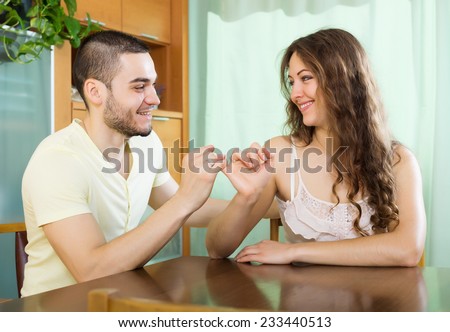 Smiling man and  happy woman having conciliation at home