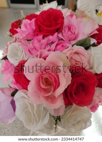 a vase filled with pink and white flowers

