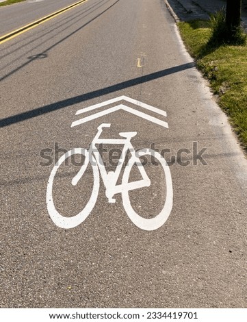 A bike lane symbol on Pennsylvania Avenue West in Warren, Pennsylvania, USA on a sunny spring day