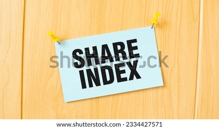 SHARE INDEX sign written on sticky note pinned on wooden wall
