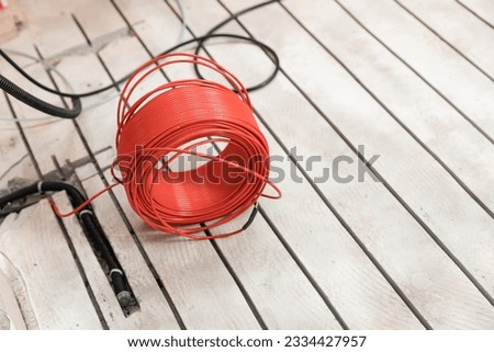 Cuts concrete floor for electrical cable, worker Install underfloor heating. Royalty-Free Stock Photo #2334427957