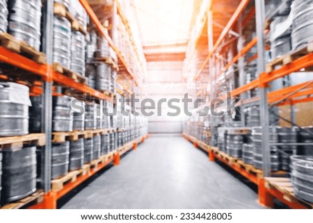 Beer kegs in warehouse of modern brewery stock, blurred background with sunlight. Royalty-Free Stock Photo #2334428005