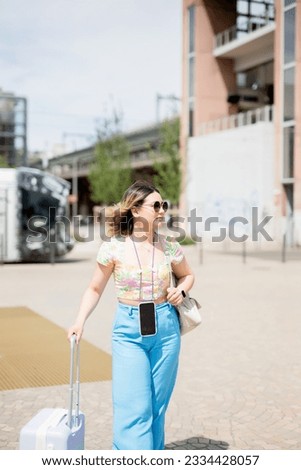 Happy young woman at train station.