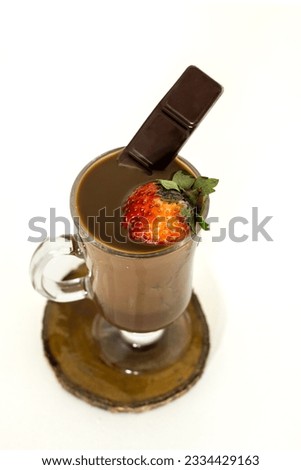 cup of hot chocolate with strawberry and chocolate bar