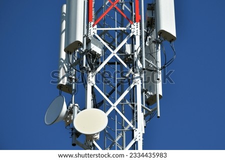 Telecommunication tower with white antenna