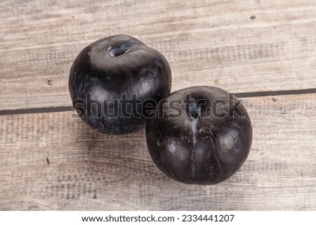 Two ripe sweet black plums isolated