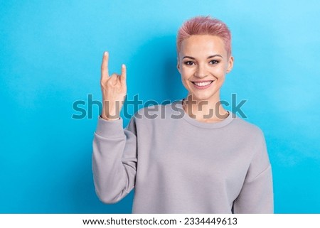 Photo of cheerful nice person toothy smile hand fingers demonstrate heavy metal symbol isolated on blue color background