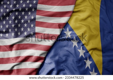 big waving colorful flag of united states of america and national flag of bosnia and herzegovina . macro