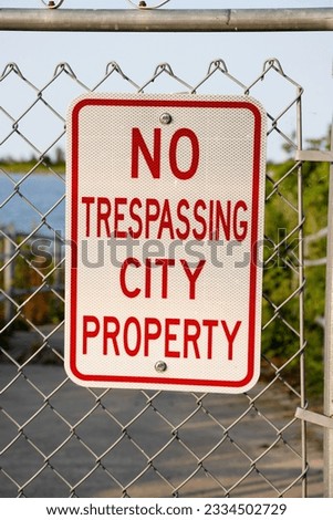 "No Trespassing City Property" Street Sign Mounted on a Wire Fence