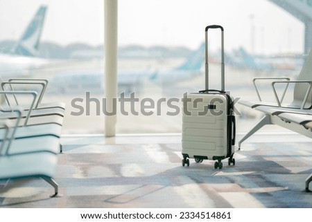 The suitcases in an empty airport hall, traveler cases in the departure airport terminal waiting for the area, vacation concept, blank space for text message or design Royalty-Free Stock Photo #2334514861