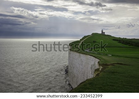 Lighthouse in the edge of famous white cliffs of Dover, England. Royalty-Free Stock Photo #233452399