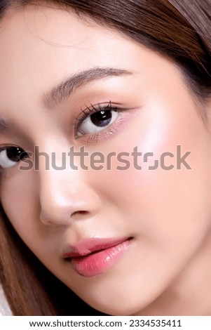 Close up Beautiful young Asian woman with healthy and perfect facial skin on isolated white background. Facial and skin care concept for commercial advertising.