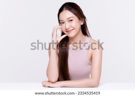 Beautiful young Asian woman with healthy and perfect skin on isolated white background. Facial and skin care concept for commercial advertising. Royalty-Free Stock Photo #2334535419