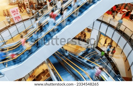 People on many fast moving escalators in modern shopping mall Royalty-Free Stock Photo #2334548265