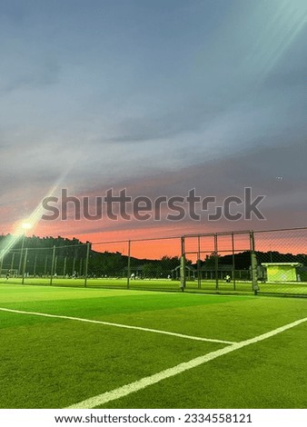 a soccer field with beautiful sunset