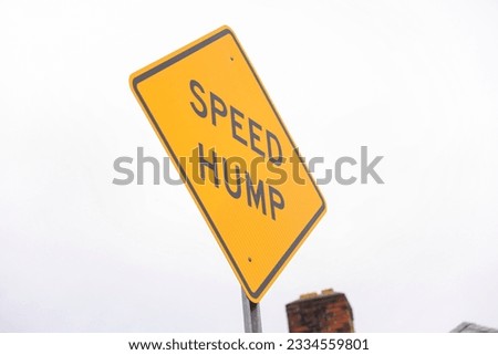 speed bump on a street symbolizes traffic control, caution, and slowing down for safety. It represents the need to be vigilant and considerate of others Royalty-Free Stock Photo #2334559801