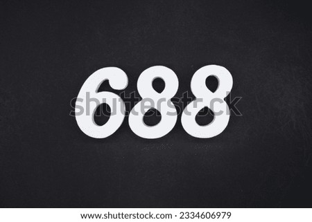 Black for the background. The number 688 is made of white painted wood.