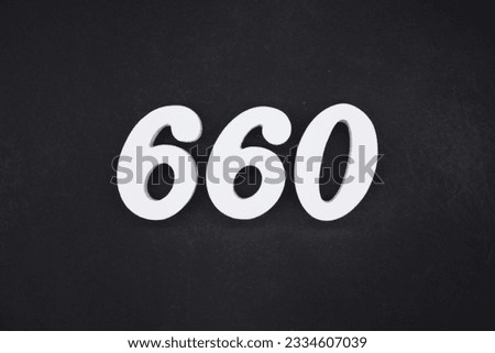 Black for the background. The number 660 is made of white painted wood.