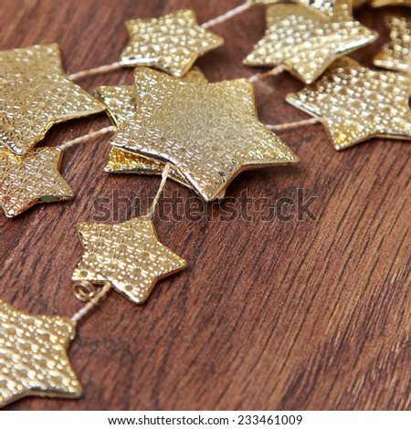 Christmas decoration golden stars over rustic Elm wood background - retro style design, copy space/Christmas decoration golden stars over wooden background o Holiday theme