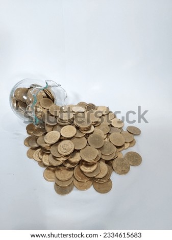 Stacks of golden money coin on wooden desk and white background