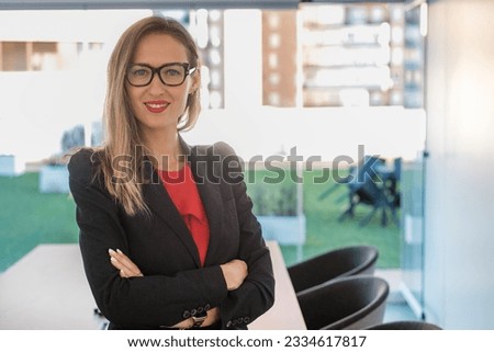 Business woman in corporate photo of executive of her company in the office. Concept: business, investment, female boss