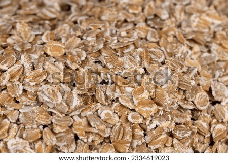 a bunch of fresh dry oatmeal flakes for making porridge, a large number of large oatmeal flakes for making breakfast Royalty-Free Stock Photo #2334619023