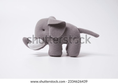  Grey colored toy elephant on a white background                               