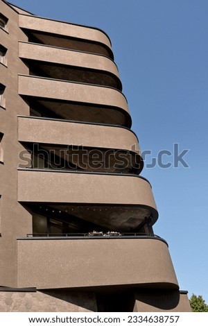 corner of a modern building with wide rounded balconies