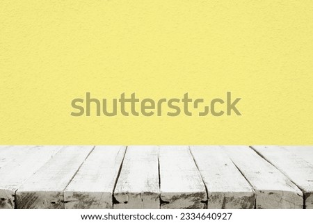selective focus.white empty of wood table top on yellow pastel color background.For montage product display or design key visual layout