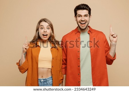 Young insighted smart proactive couple two friends family man woman wear casual clothes hold index finger up with great new idea together isolated on pastel plain light beige color background studio