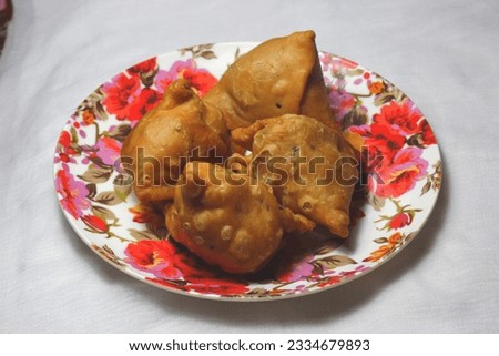 Singara. This is known as  potato "Singara" in Bangladesh. In India it is known as samosa. Royalty-Free Stock Photo #2334679893