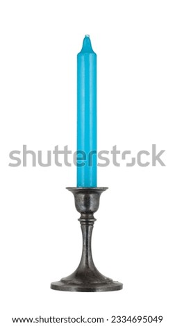 Metal candle holder with blue candle. Decorative item, retro. On a white background. Royalty-Free Stock Photo #2334695049