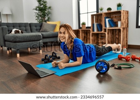 Young caucasian woman smiling confident training core exercise at home
