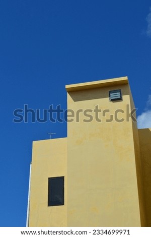 stucco building structure against the background of clouds and blue sky during the day