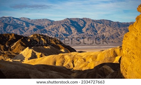panorama of the mountains in golden canyon during the spring sunrise; the famous coloured mountains which can be seen from zabriskie point; hiking in golden canyon in death valley national park	 Royalty-Free Stock Photo #2334727663