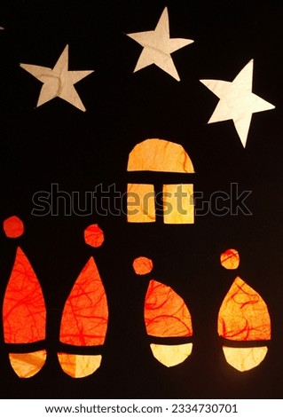 Christmas elves peep through the windows by candlelight