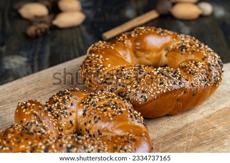 soft and fresh wheat bagel sprinkled with white and black sesame seeds, cooked wheat flour bagels and covered with sesame seeds Royalty-Free Stock Photo #2334737165