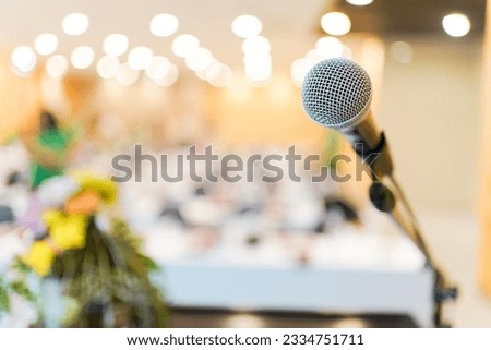 Wired microphone set up on the front of conference room close up with blurred background.  Wired microphone close up with copy space background. Royalty-Free Stock Photo #2334751711