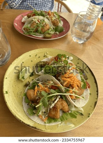 Shrimp tacos in colorful plates served in an authentic Mexican restaurant in Lisbon, Portugal.
