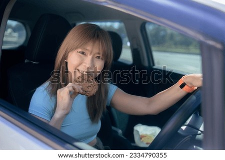 Women eating homemade cookies while driving car in the city