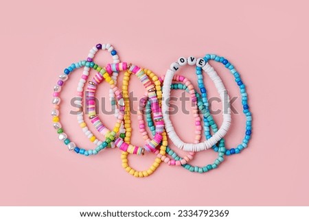 Kids handmade beaded jewelry. Necklaces and bracelets made from multicolored beads and pearls. DIY bracelet beads. Children's needlework. Creativity and hobby. Art activity for kids Royalty-Free Stock Photo #2334792369