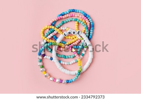 Kids handmade beaded jewelry. Necklaces and bracelets made from multicolored beads and pearls. DIY bracelet beads. Children's needlework. Creativity and hobby. Art activity for kids Royalty-Free Stock Photo #2334792373