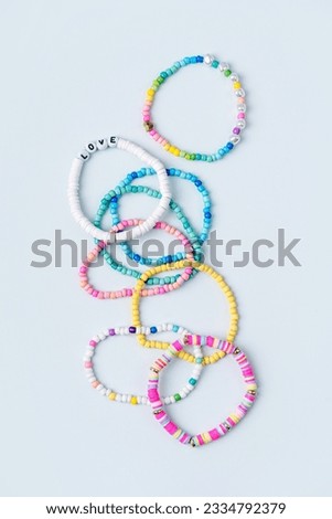 Kids handmade beaded jewelry. Necklaces and bracelets made from multicolored beads and pearls. DIY bracelet beads. Children's needlework. Creativity and hobby. Art activity for kids Royalty-Free Stock Photo #2334792379