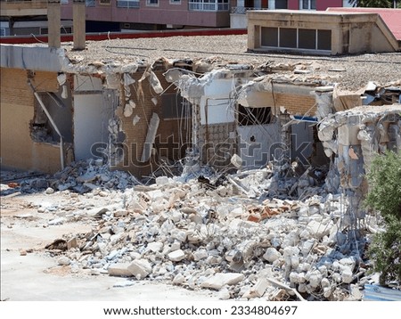 The wreckage of a destroyed building. Ruins in the background.